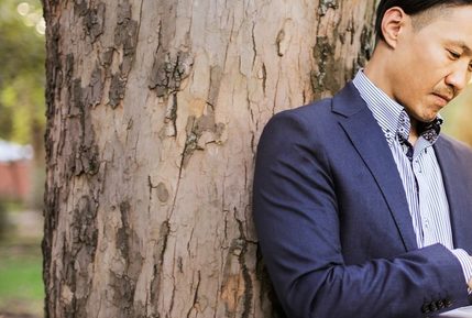 Man in suit on laptop outdoors