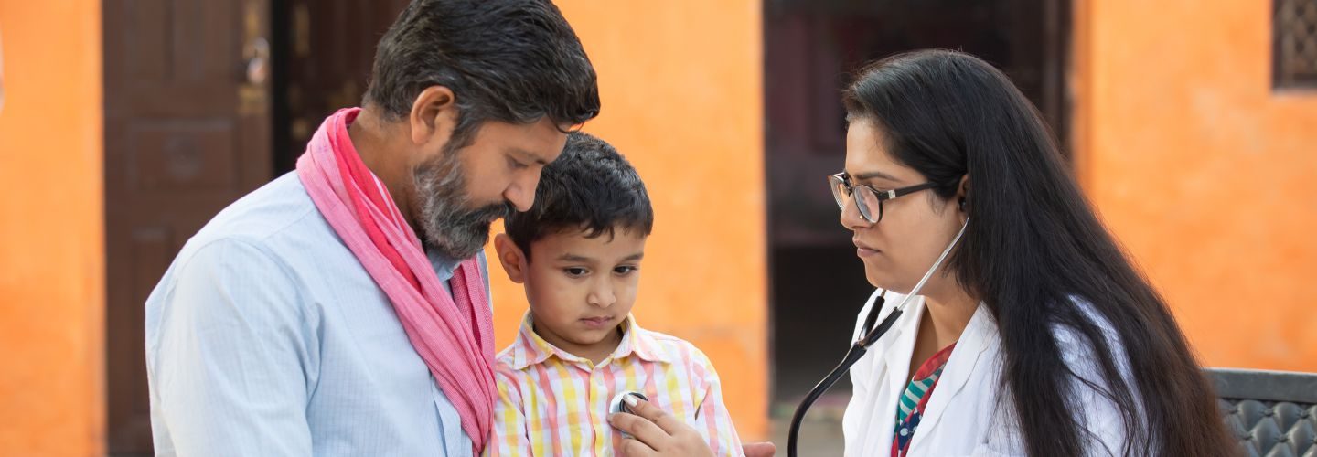 Doctor examining young boy