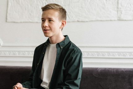 Young man smiling talking to psychology professional