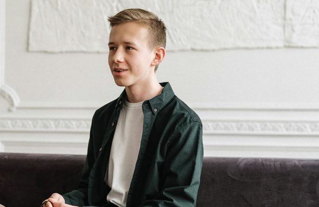Young man smiling talking to psychology professional