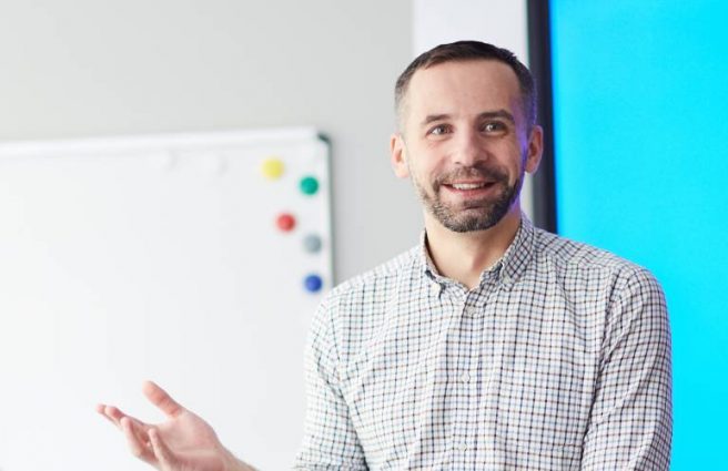 An education professional talking to students
